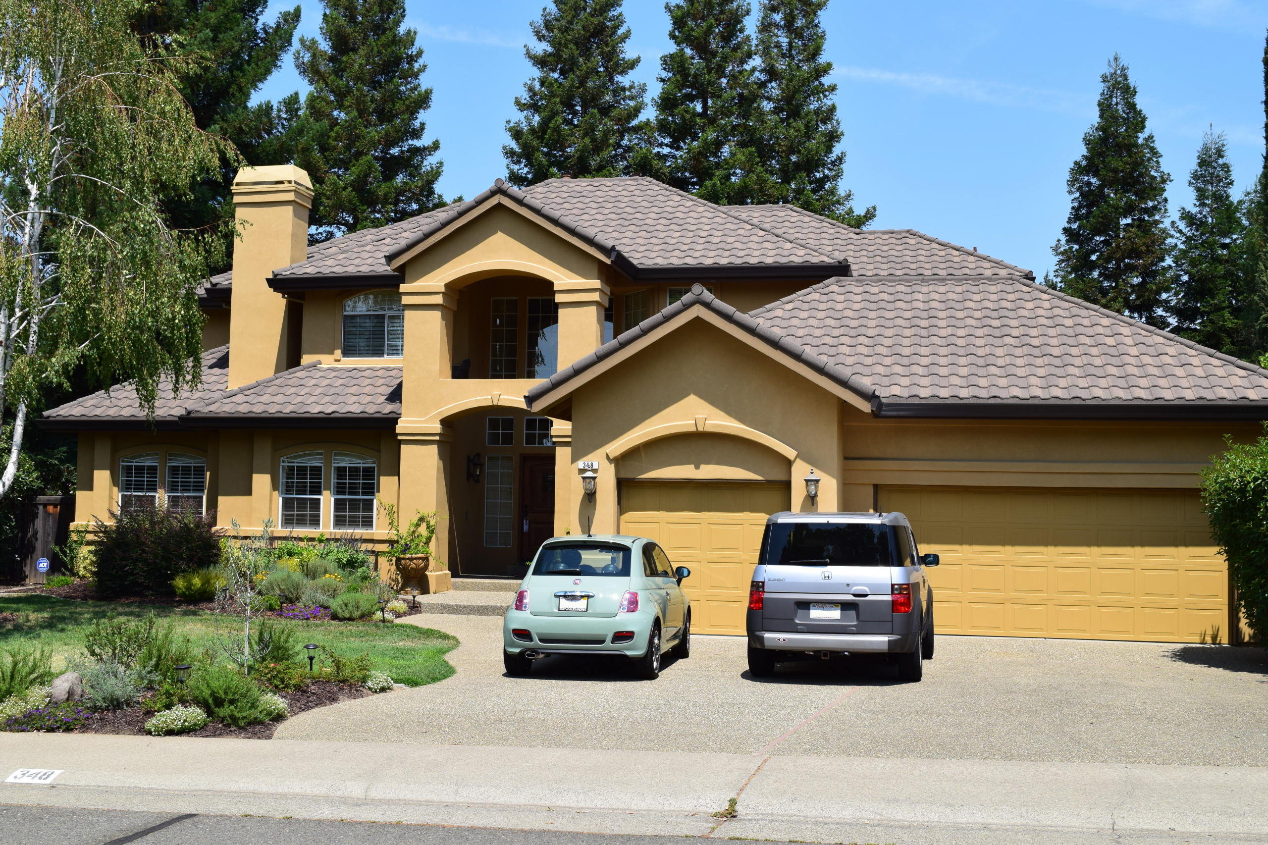 Modern two-story home with stone-coated metal roof tiles and a double garage.