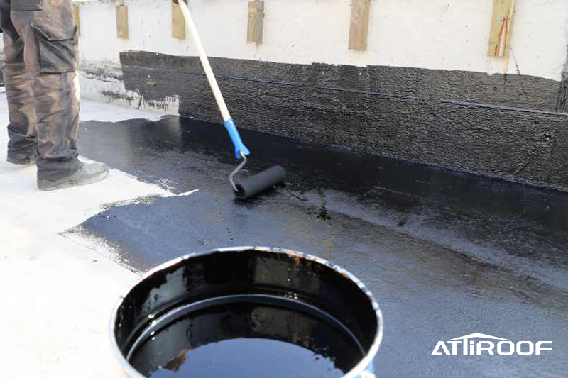 Image showing the installation of a waterproof or insulation layer on a roof.