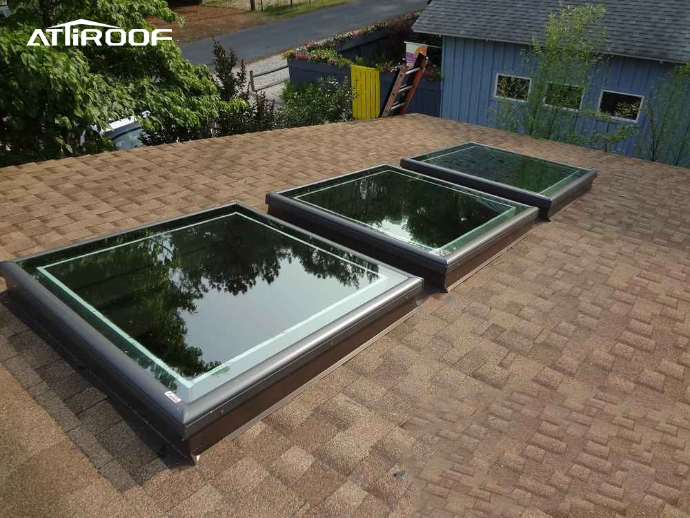 Image depicting a roof ventilation system with skylights installed on a shingle roof.