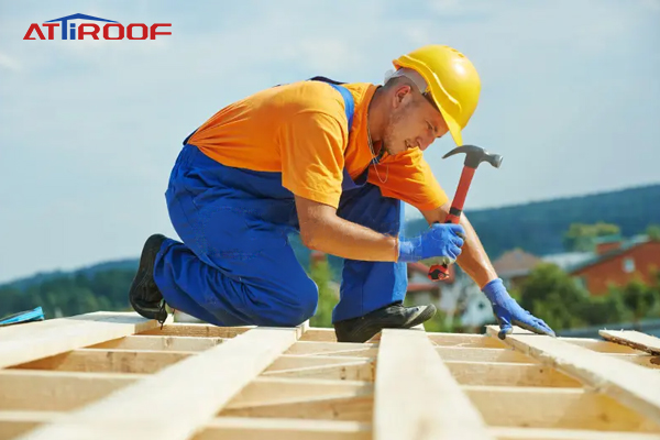 Workers wear personal protective equipment to work on the roof.